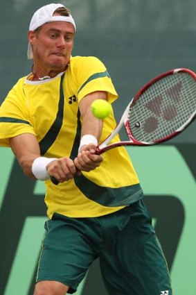 Lleyton Hewitt plays a double-handed backhand.