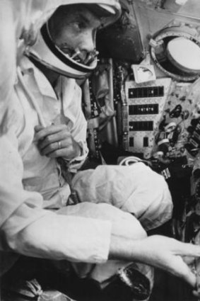 John Glenn sits in the cockpit of the Mercury spacecraft.
