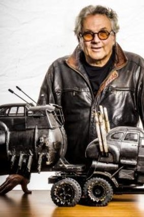George Miller shows models of vehicles in <i>Fury Road</i>.
