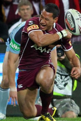 Israel Folau celebrates scoring a try for Queensland.