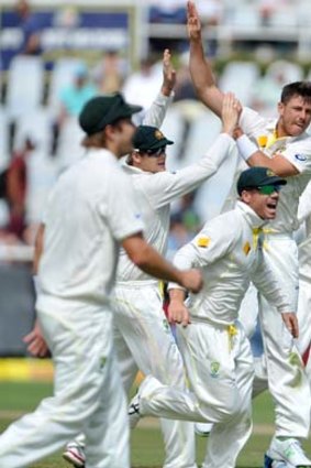 Australia's James Pattinson (2nd R) celebrates with teammates after taking the wicket of Dean Elgar.