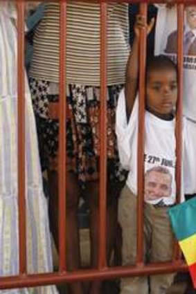 Is he here yet? A child waits to catch a glimpse of US. President Barack Obama