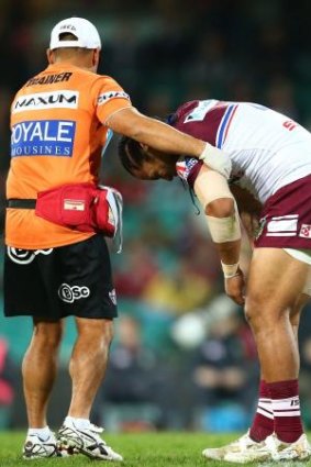 Manly's Steve Matai suffers the after-effects of George Burgess' chicken wing tackle.