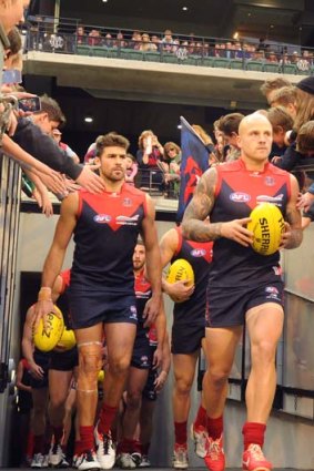 Chris Dawes and Nathan Jones lead out the Melbourne team on Sunday.