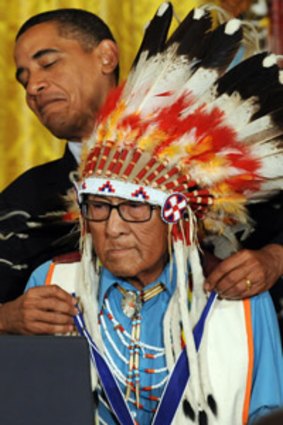A ticklish situation . . . Barack Obama places the Medal of Freedom around the neck of Joseph Medicine Crow, a native American tribal chief.