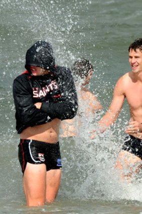 Cop this: St Kilda’s Justin Koschitzke makes a pest of himself at a recovery session yesterday.