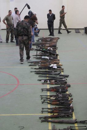 Syrian troops display weapons allegedly seized from armed dissidents.