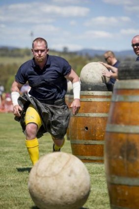 Focused: Strongman Moe Westmoreland moves in for the challenge during the Stones of Manhood competition at the Canberra Highland Gathering & Scottish Fair in Kambah.