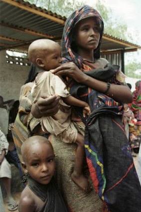 Doomed ... a Somali women waits for a medical check  with her malnourished children in the town of Baidoa.