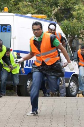 Paramedics run outside the Westgate mall in Nairobi after heavy shooting.