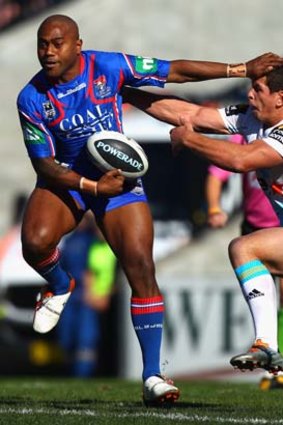 Akuila Uate of the Knights fends off Greg Bird.