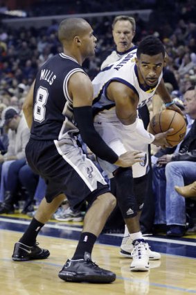 San Antonio Spurs guard Patty Mills defends against Memphis Grizzlies counterpart Mike Conley.