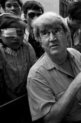 Famous image: Professor Fred Hollows examines the eyes of nine-year-old Tran Van Giap at Hanoi's Institute of Ophthalmology by Michael Amendolia.