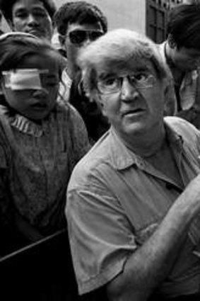 Famous image: Professor Fred Hollows examines the eyes of nine-year-old Tran Van Giap at Hanoi's Institute of Ophthalmology by Michael Amendolia.