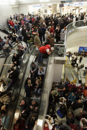 Passengers fill the terminal after a security breach shut down Terminal C at Newark Liberty International Airport.
