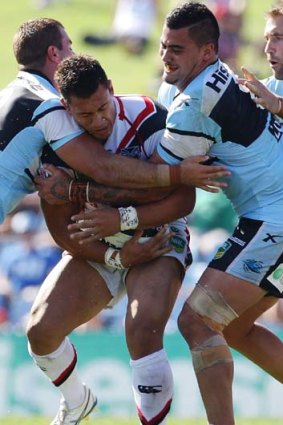 Fierce defence: Elijah Taylor and his Warriors side found the Sharks line hard to crack.