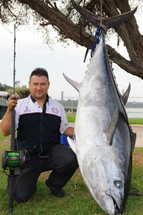 Steve Makarios and the tuna he reeled in.