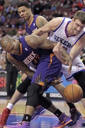 Phoenix Suns forward P.J Tucker and Philadelphia 76ers centre Spencer Hawes fight for ball control.