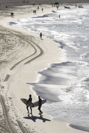 Come on in: Balmy temperatures lure surfers to Bondi Beach.