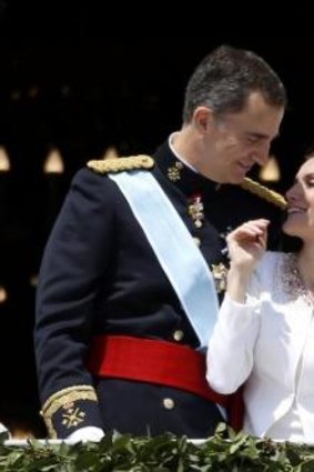Balcony scene: Spain's new King, Felipe VI, embraces his wife Queen Letizia.