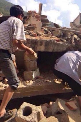 Residents look for survivors in the rubble of a collapsed house in Ludian county in Zhaotong.