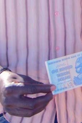 A man holds the $100 trillion dollar note.