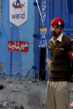 Pakistan army soldier stands at the site of a suicide bombing in Rawalpindi.