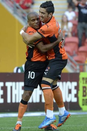 Brisbane's Henrique celebrates with Dimitri Petratos after scoring against Melbourne Heart.