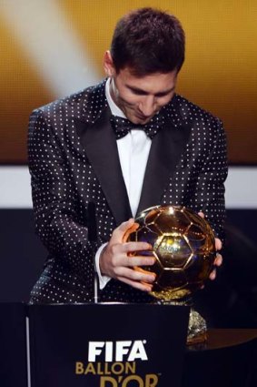 Lionel Messi with his fourth Ballon d'Or award.