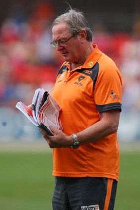 Giants coach Kevin Sheedy checks his notes as leaves the field after talking to his players.
