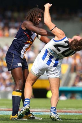 Toe to toe: West Coast's Nic Naitanui and North's Drew Petrie clash in last year's elimination final in Perth.