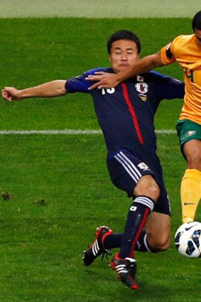 Tim Cahill in action against Japan's Yasuyuki Konno during last week's qualifier in Saitama.