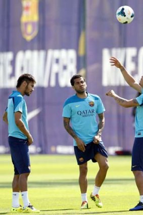 Barcelona's Neymar, Dani Alves and Adriano attend a training session at Joan Gamper training camp on Friday.