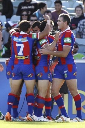 Kinghts players celebrate a try against the Raiders.
