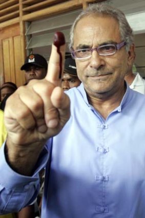 East Timor's President Jose Ramos-Horta shows off his inked finger after casting his ballot during the presidential election in Dili.