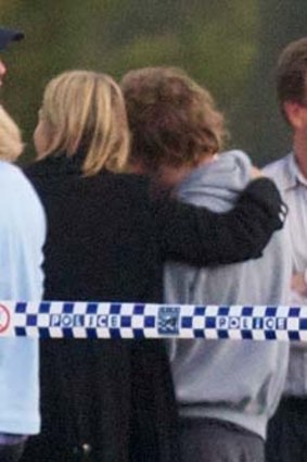 Madeleine's father, William Pulver, waits at the scene last night with shocked family and friends.