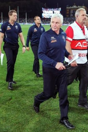 Mick Malthouse leaves the field after the game.