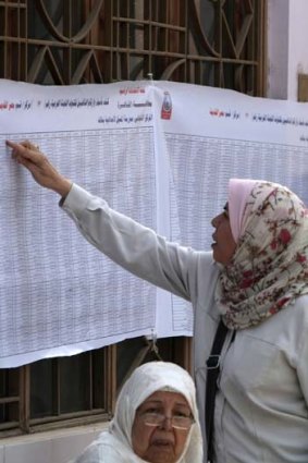 Everybody counts ... voters check their name off at a polling station in Alexandria. Thirteen candidates are on the list, with five front-runners.