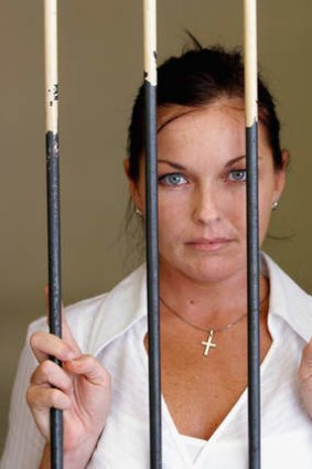 Schappelle Corby stands behind the bars in the holding cell at Denpasar District Court, Bali in August.