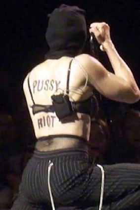 Praying for their freedom ... Madonna performed during her Moscow concert with the words "Pussy Riot" on her bare back, in support of the jailed feminist punk band.