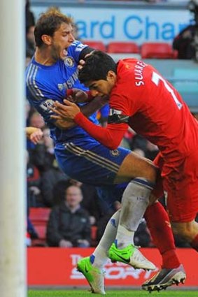 Ouch: Liverpool's Luis Suarez (right) clashes with Branislav Ivanovic after appearing to bite the Chelsea defender.