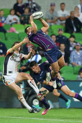 Mahe Fonua of the Storm catches the ball over Joel Reddy of the Tigers.
