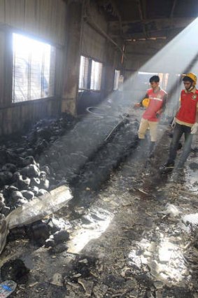 Ruins: Bangladeshi rescue workers examine what remains of the factory.