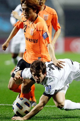 On the run: Victory's Bobby Kruse battles for the ball in last night's draw with Jeju United.