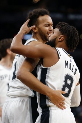 Strong showing: Patty Mills with teammate Kyle Anderson.
