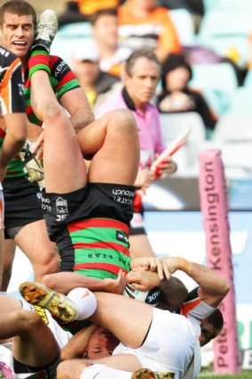 Head over heels ... Nathan Peats of the Rabbitohs scores a try.