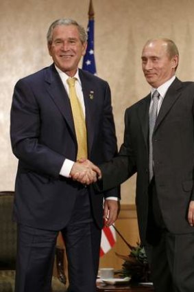 Mr Putin and former US President George W Bush shake hands following their bilateral meeting in Sydney in 2007.