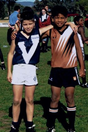 Trent Cotchin and Cyril Rioli in 2001 and (below) when they got together in Alice Springs last week.