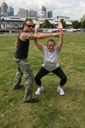 Smiling through the pain ... Commando Steve Willis puts ocean swimmer Georgina Robinson through her paces.