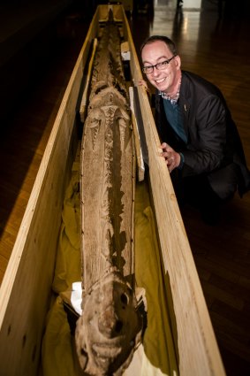 National Gallery of Australia  Pacific Arts curator Crispin Howarth with the 6.3 metre cult crocodile from Papua New Guinea, which is on display at the gallery.

